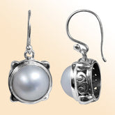 Sterling silver earrings with round white pearl in Bali-inspired design for retail customers.
